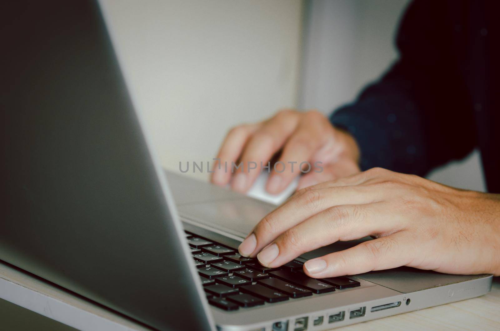 Man hand using a computer to type on a keyboard to find information on the Internet on social networks. by aoo3771