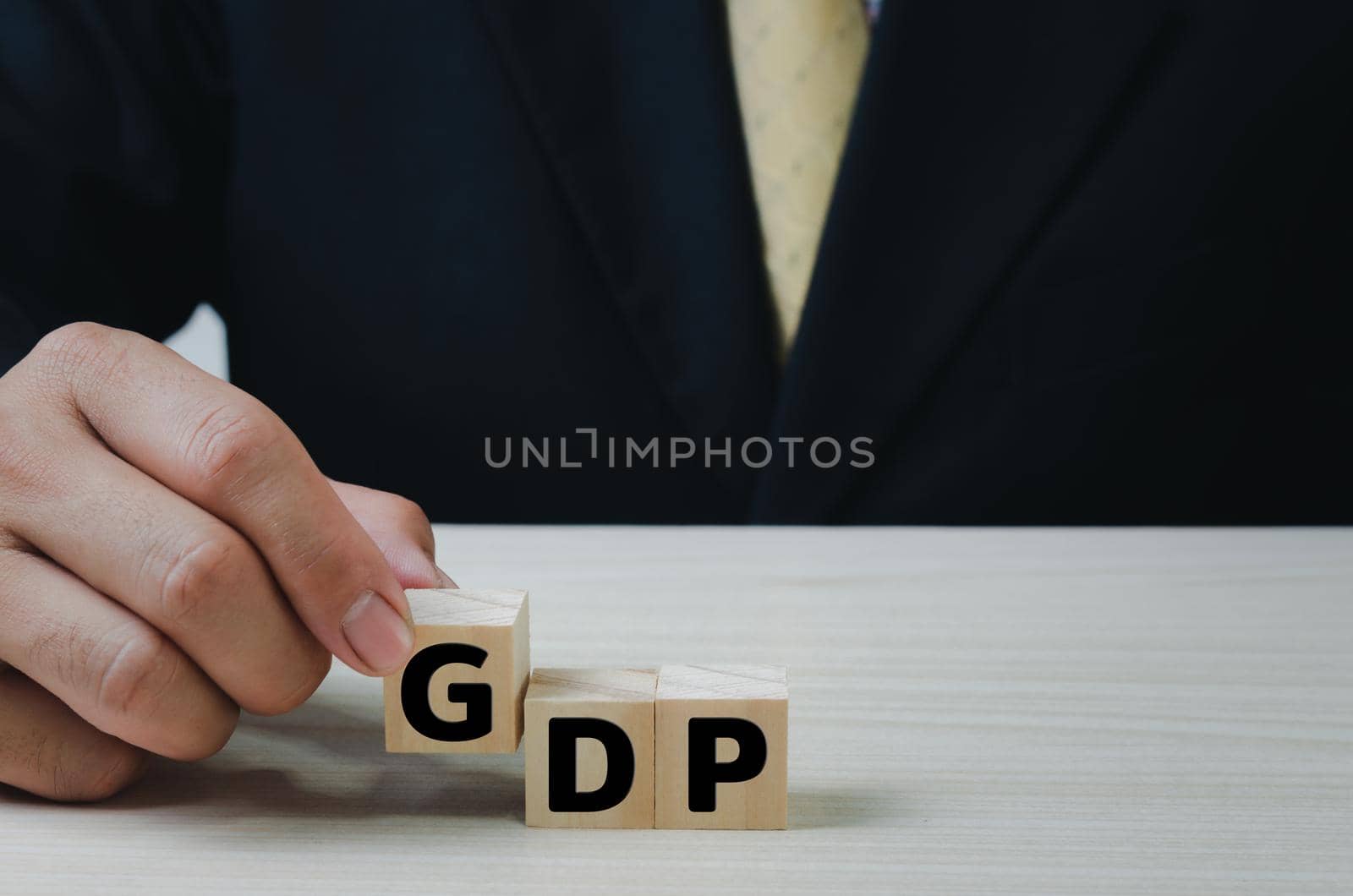 Hand put wooden cubes with GDP text Gross domestic product on table copy space.Business Financial Management Economic concepts.