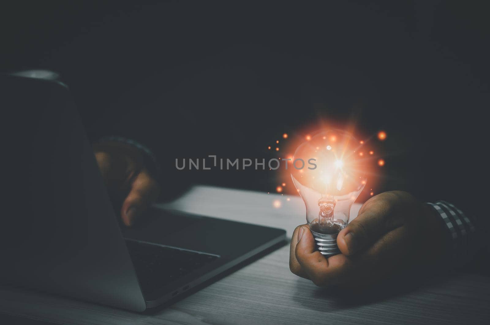 businessman holding a light bulb with a laptop computer.Digital creative design concept technology marketing. by aoo3771