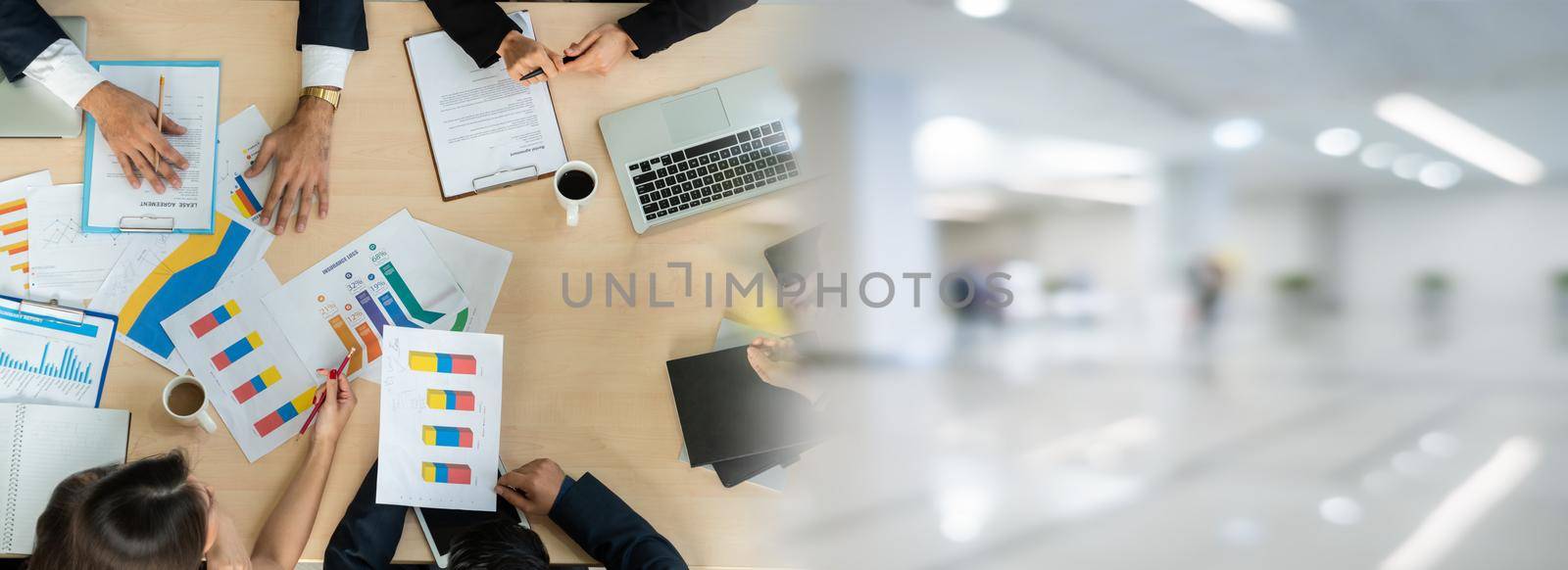 Business people group meeting shot from top widen view in office . Profession businesswomen, businessmen and office workers working in team conference with project planning document on meeting table .