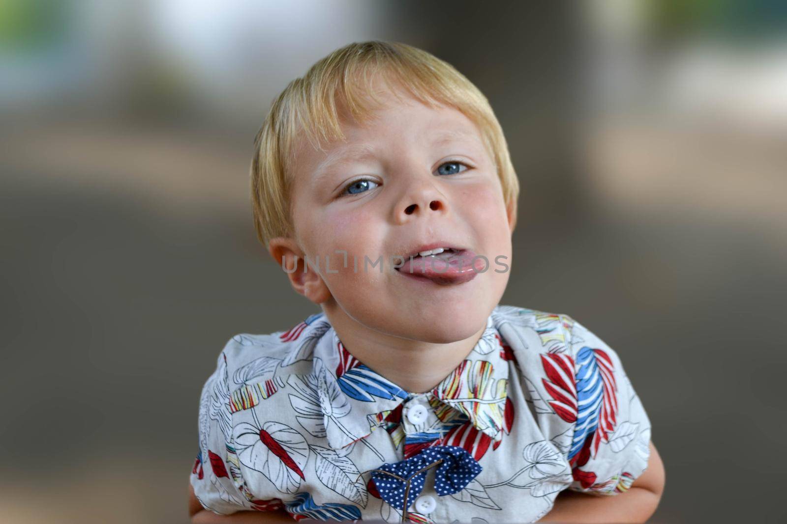 Blond boy 4 years old playing on a children playground and has fun. High quality photo