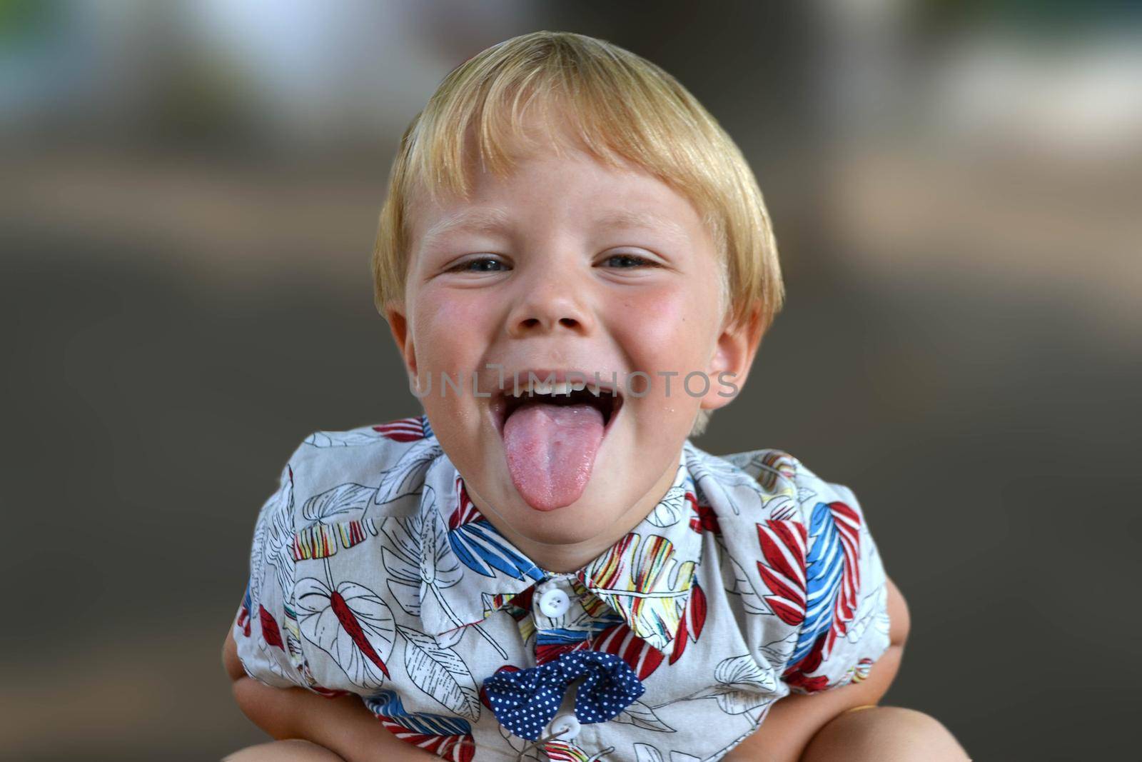 Blond boy 4 years old playing on a children playground and has fun. High quality photo