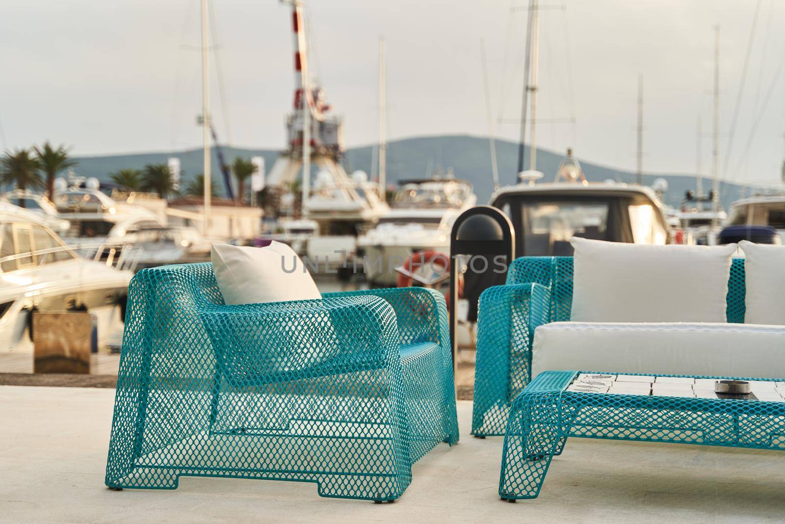 Wicker blue chair, sofa and table. Summer outdoor furniture on the seashore. High quality photo