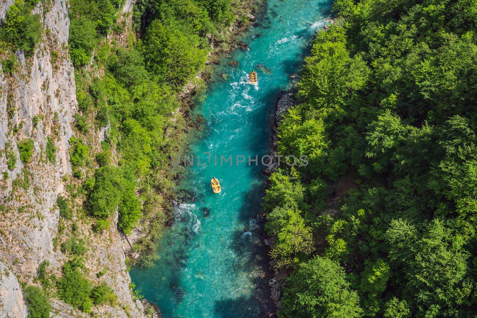 Famous rafting and kayaking place. Active kayakers in colorful life jacket paddling and exercising. Rafting on the turquoise river. Montenegro natural landscape, mountain river Tara.