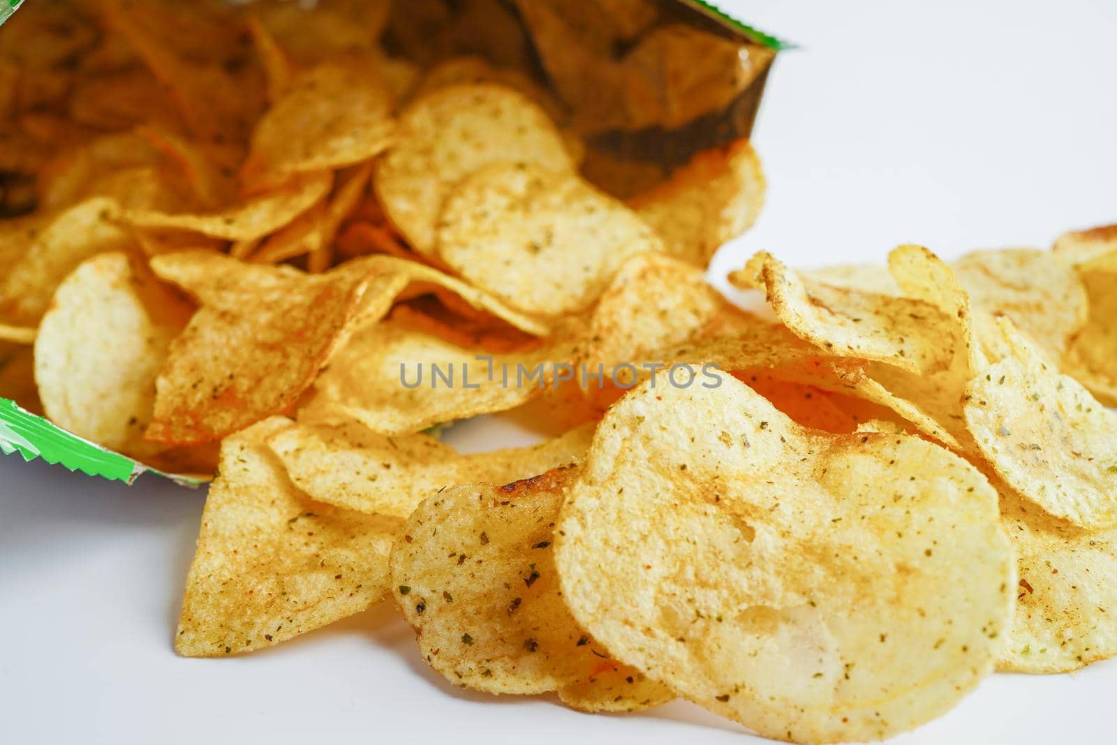 Potato chips in open bag, delicious BBQ seasoning spicy for crips, thin slice deep fried snack fast food in open bag.