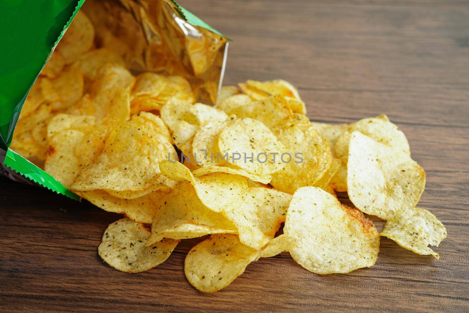 Potato chips in open bag, delicious BBQ seasoning spicy for crips, thin slice deep fried snack fast food in open bag.