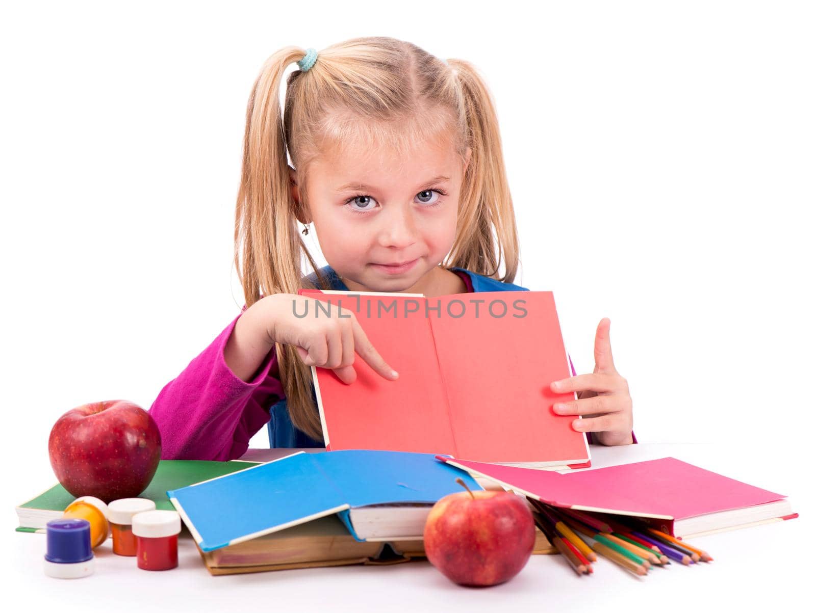 Little smart girl holding a book and reading it, on a white background by aprilphoto