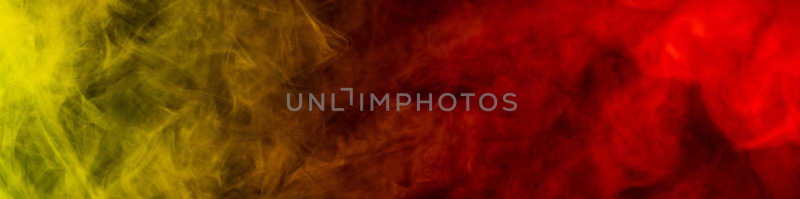 Red-yellow smoke spreads on a black background