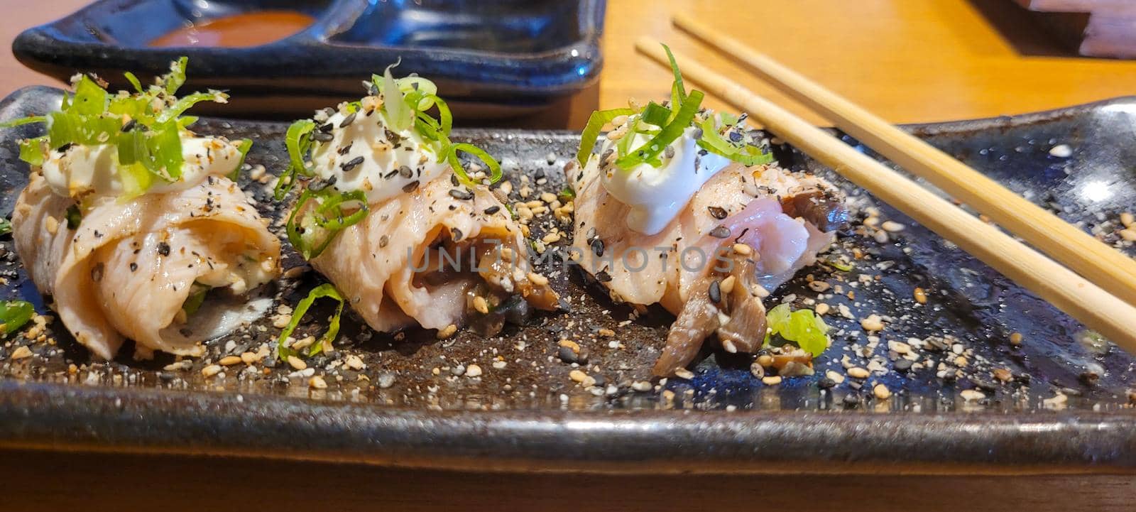 japanese food dish in an oriental restaurant with wooden table and light background