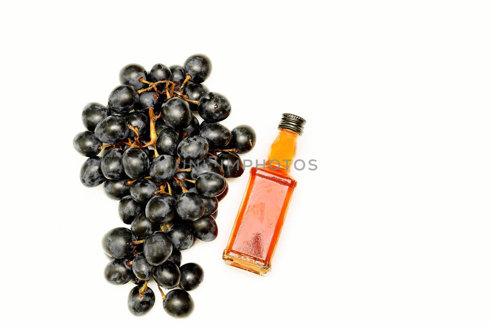 Good old brandy, cognac and black ripe grapes by jovani68