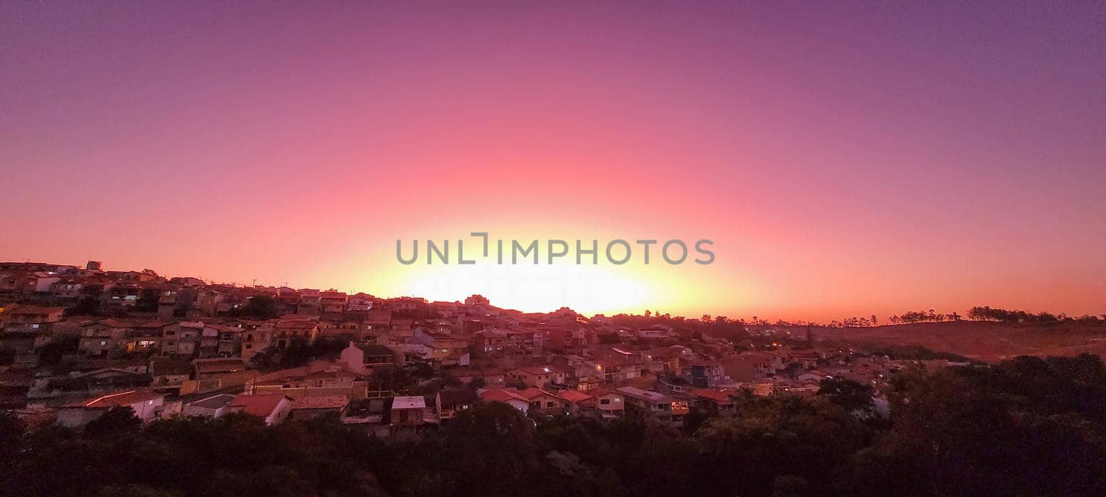 colorful late afternoon sunset in the countryside of Brazil inserting the day