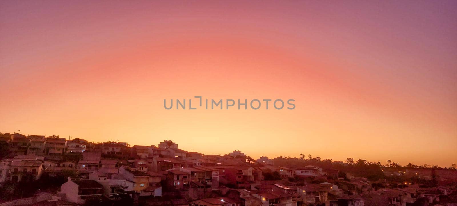 colorful late afternoon sunset in the countryside of Brazil inserting the day