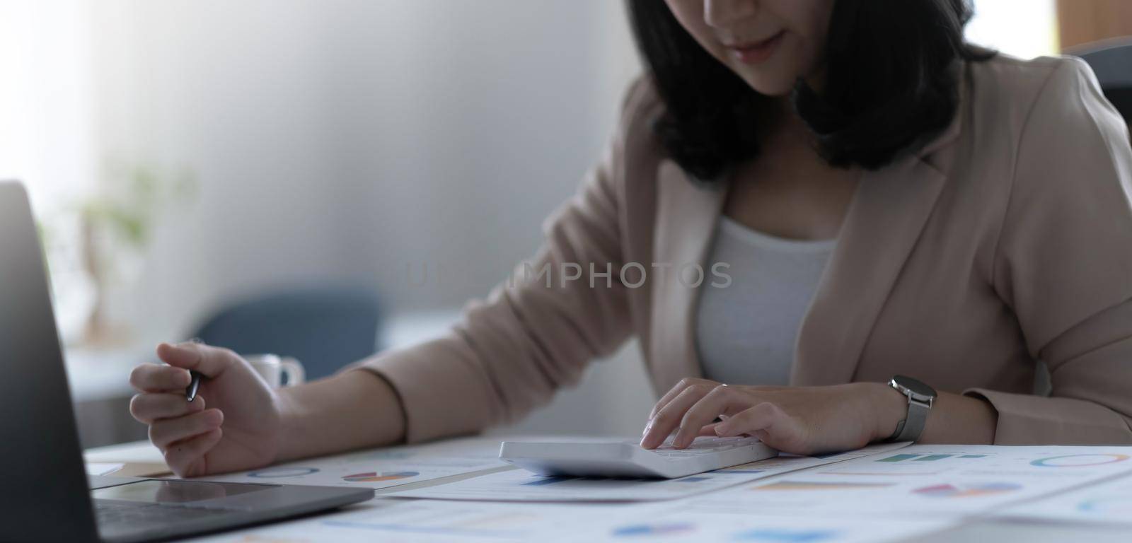 employee accountant man hand press on calculator for make financial report or company's profit monthly at desk , bookkeeper job and work from home concept.