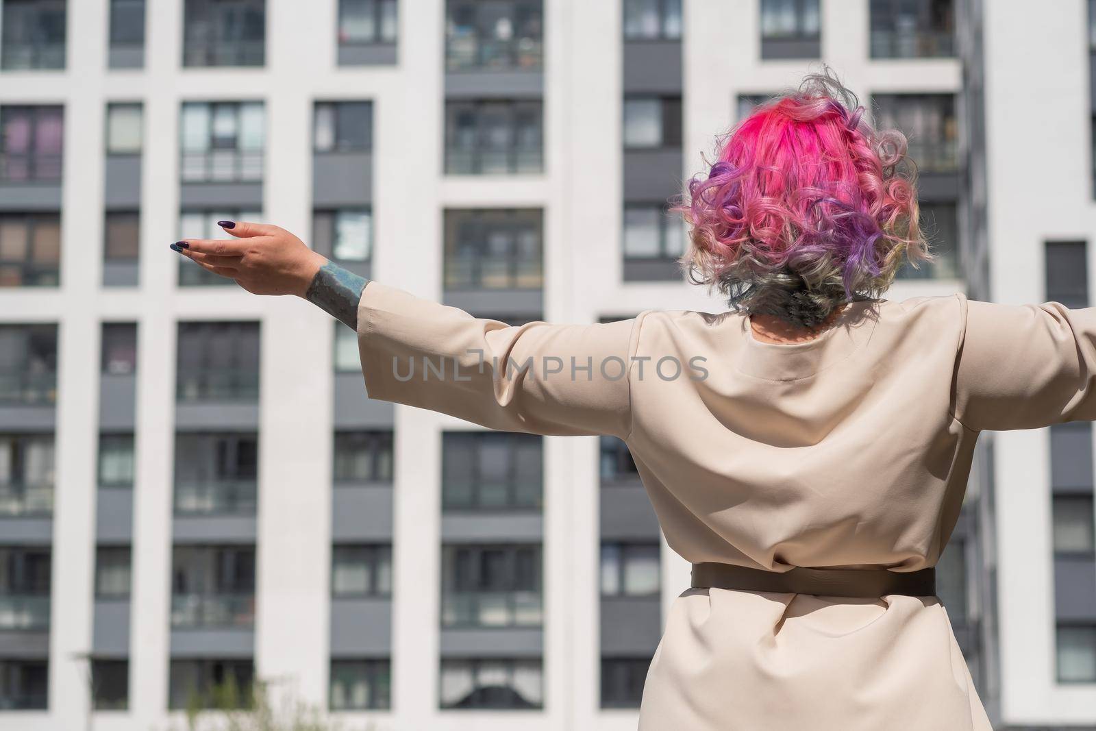 Portrait of a middle-aged woman with multi-colored hair walks on the streets of the city