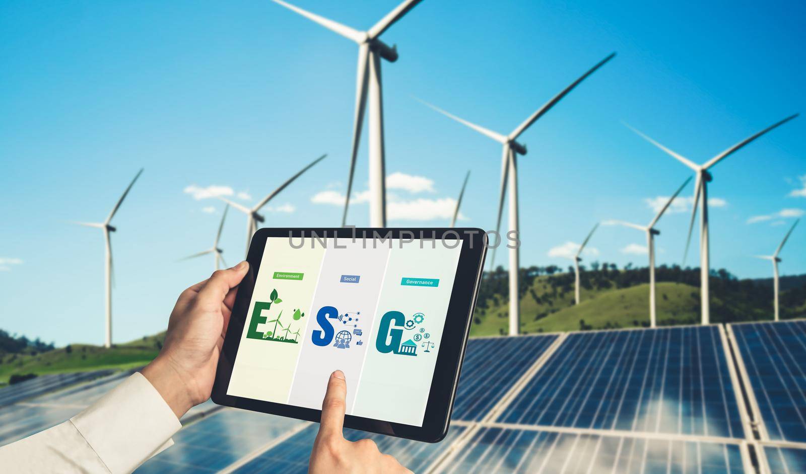 Green business transformation for environment saving and ESG business concept. Businessman using tablet to set corporate goal toward environmental friendly management and alternative clean energy use.