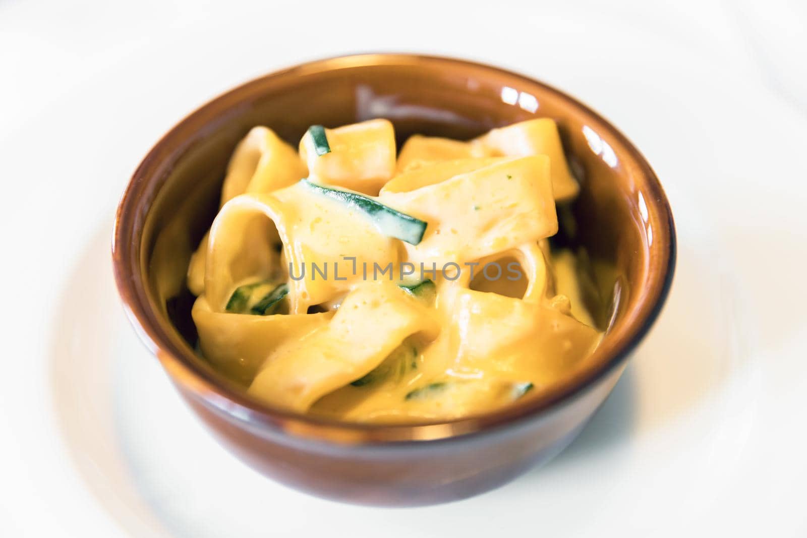 Calamarata pasta (macaroni) with cream and zucchini