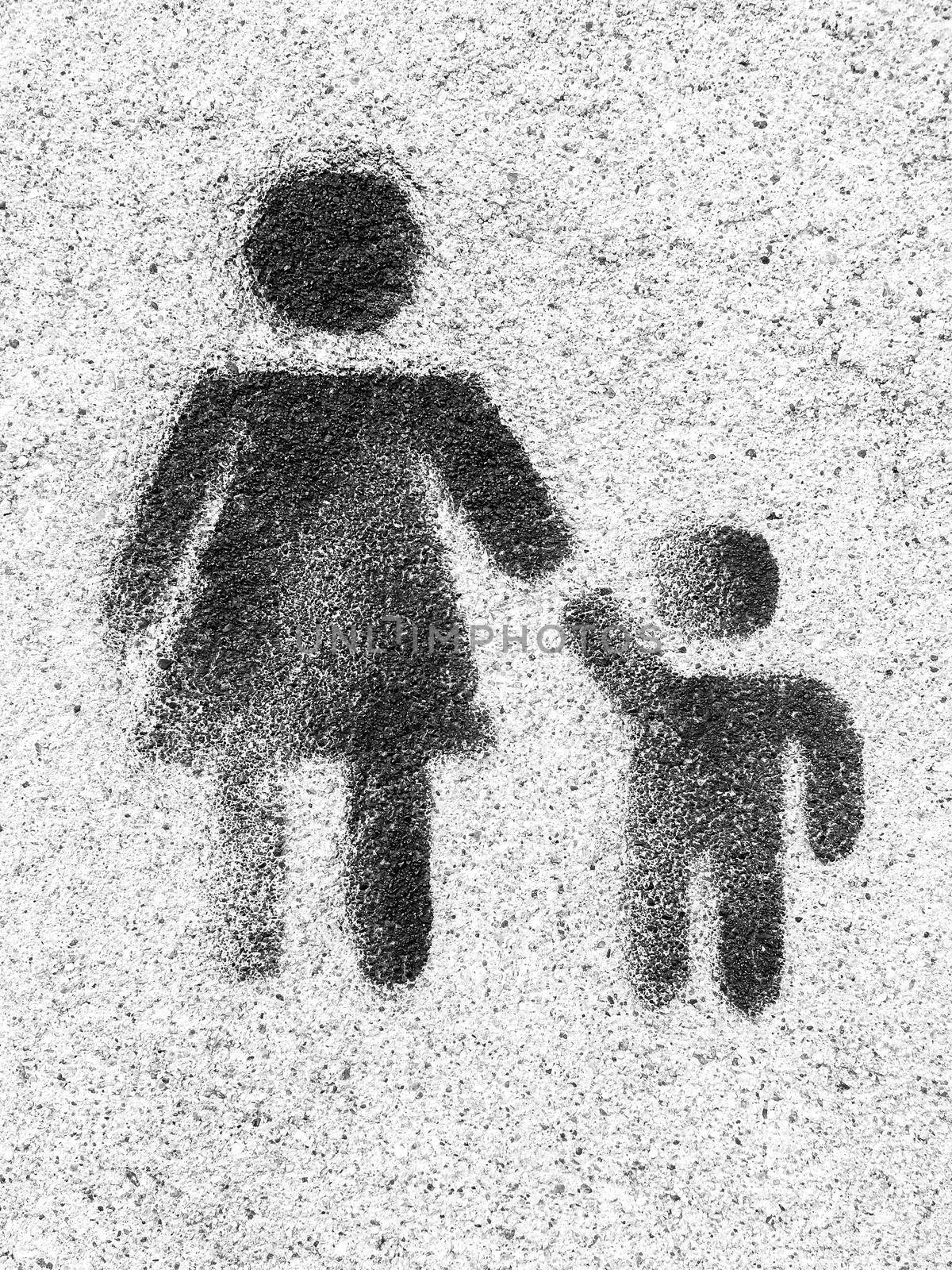 Family symbol. Mother and son are kept each other's hands. Love. Graffiti on wall as background.