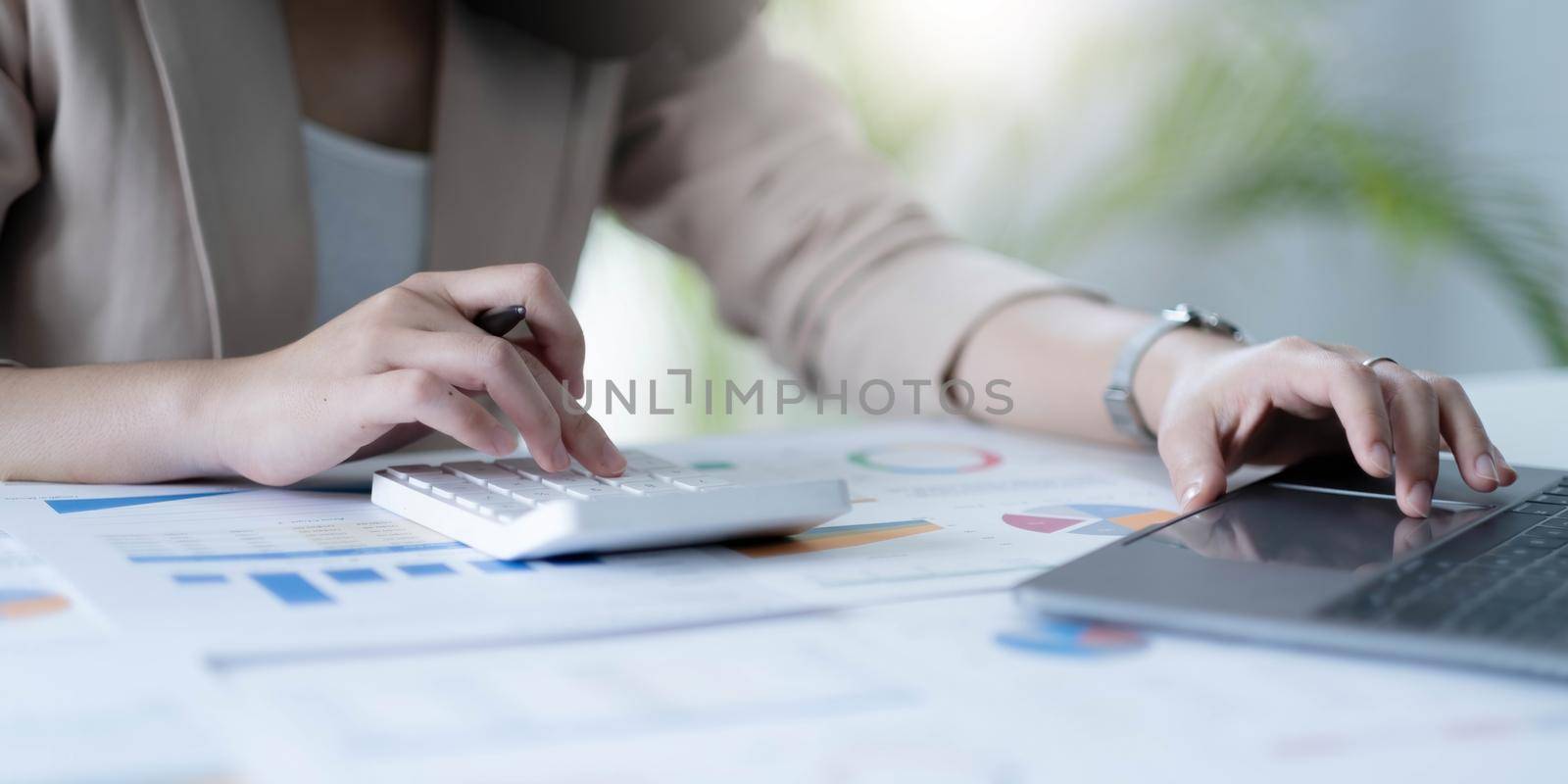 employee accountant woman hand press on calculator for make financial report or company's profit monthly at desk , bookkeeper job and work from home concept.