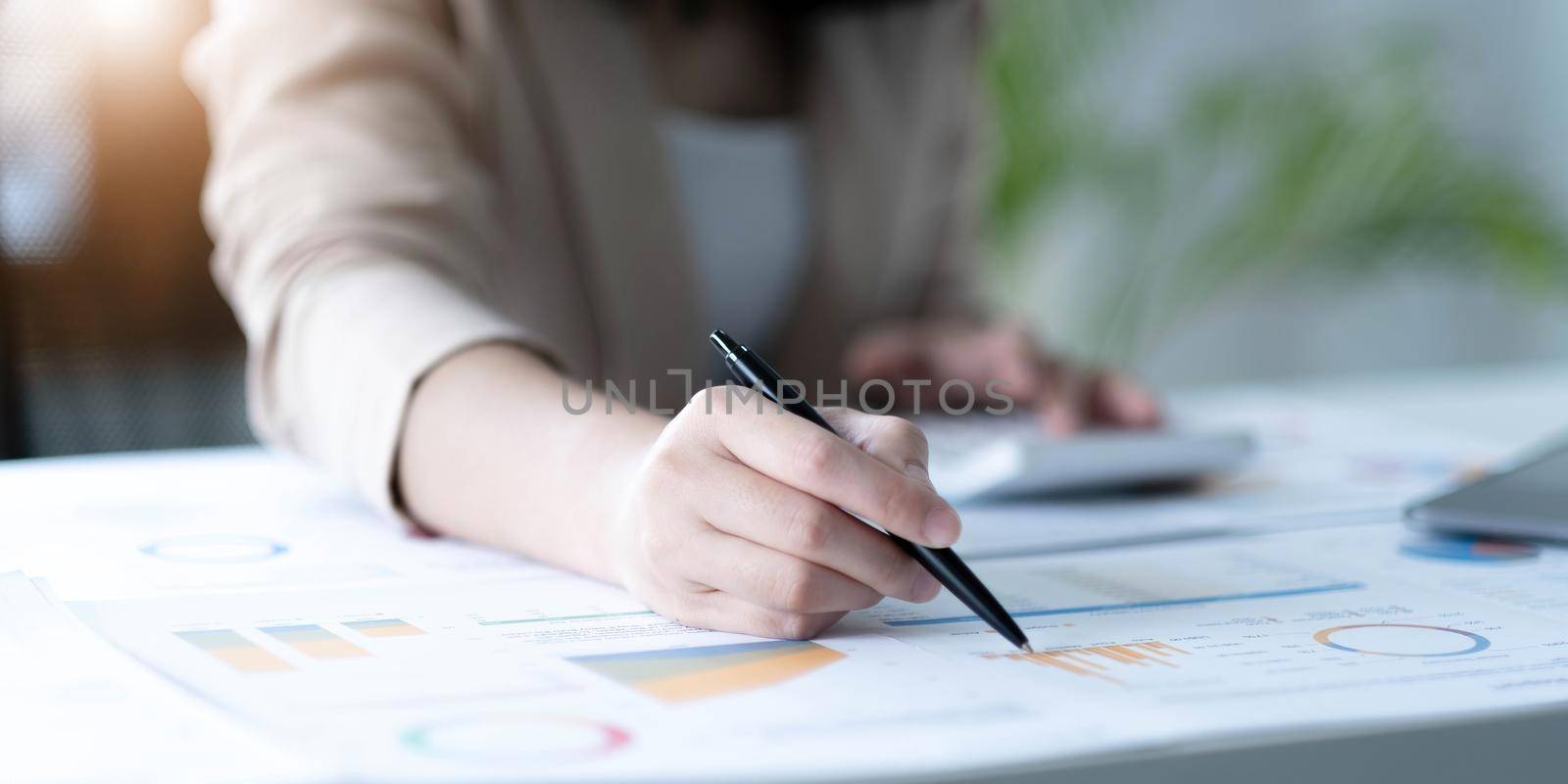 Close up of Business woman investment consultant analysis company annual financial report balance sheet statement working with documents graphs. Concept picture of economy, marketing.