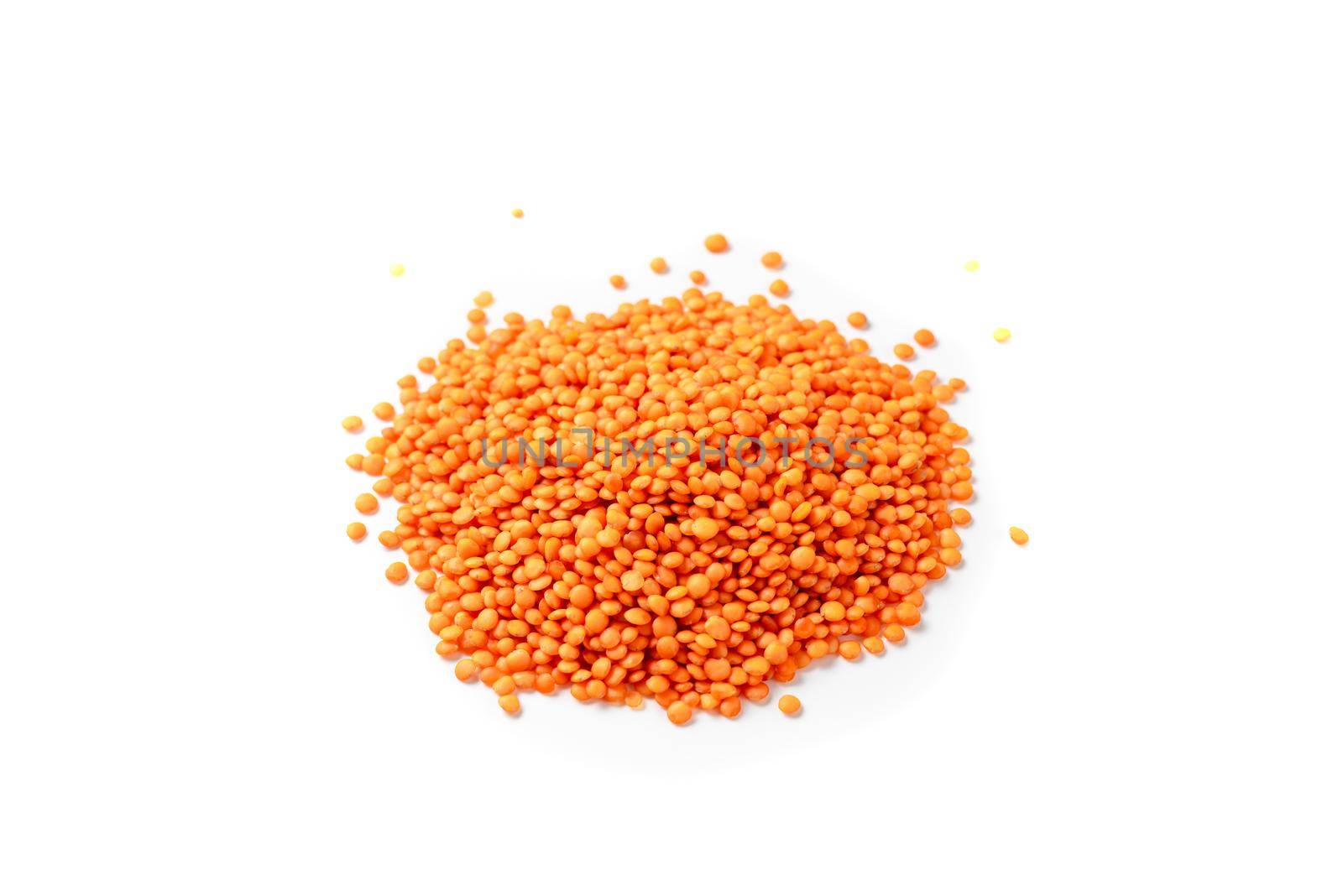 Dry red lentils on a white background isolate. Red lentil grits. Red lentils pile isolated. Dry orange lentil grains, heap of dal, raw daal, dhal, masoor, Lens culinaris or Lens esculenta on white background