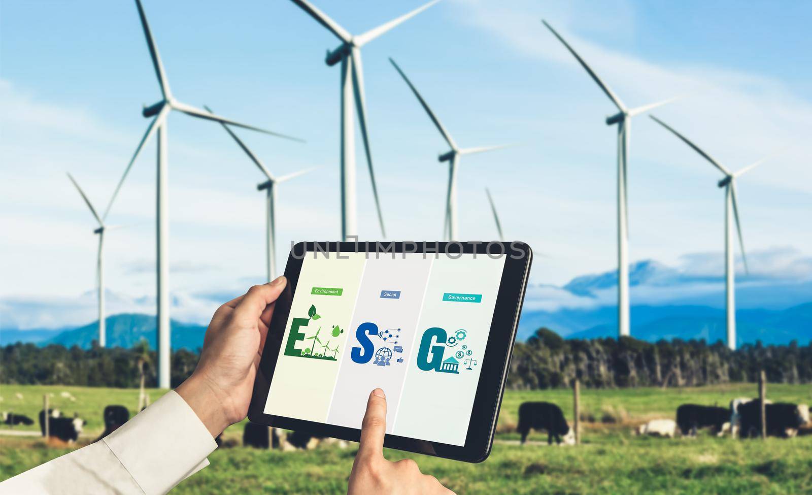 Green business transformation for environment saving and ESG business concept. Businessman using tablet to set corporate goal toward environmental friendly management and alternative clean energy use.
