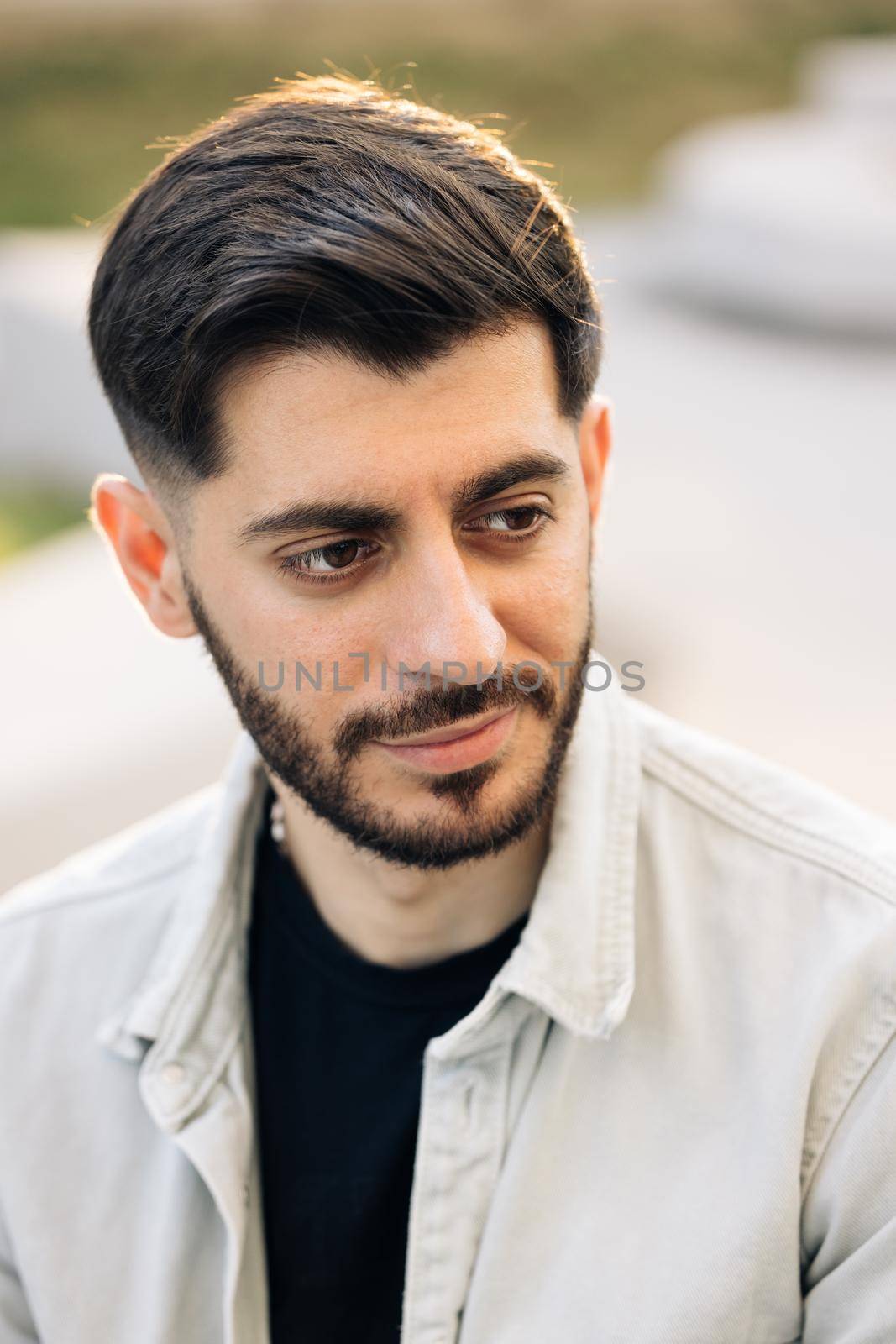Portrait of young caucasian bearded man opening his eyes. Male beautiful brown eyes looking at camera. Confident guy with attractive and deep sight.