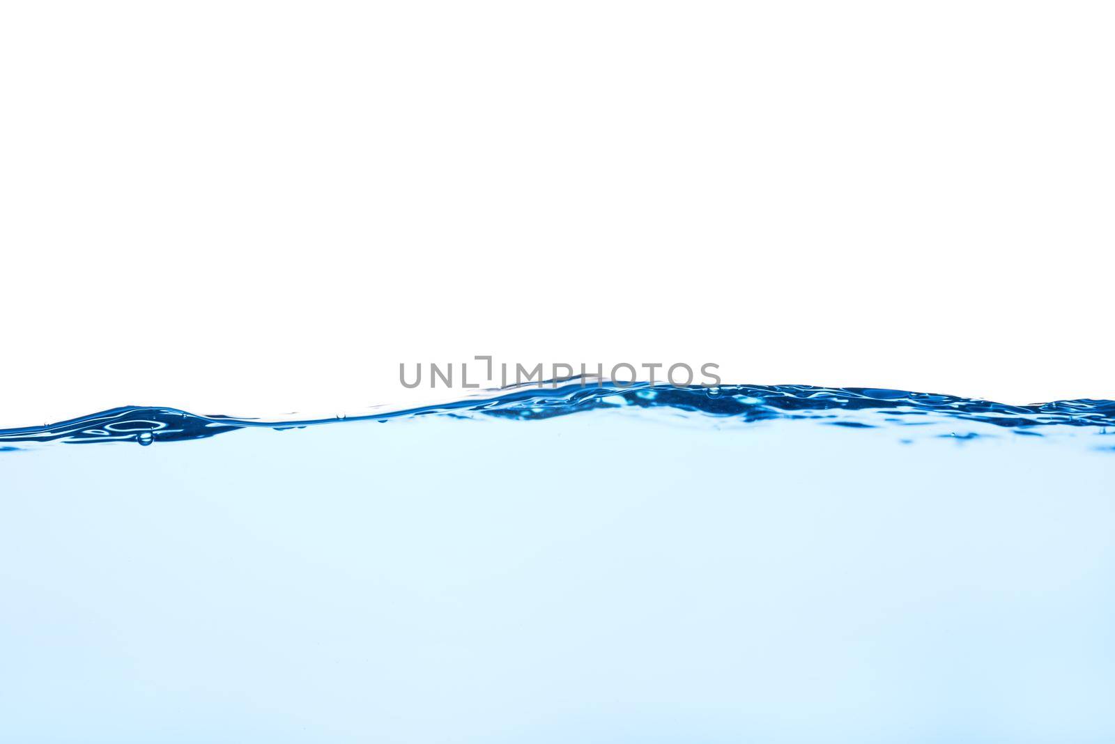 Light blue water wave with air bubbles and a little bit splashed underwater, studio shot isolated on white background. The abstract clean surface on liquid