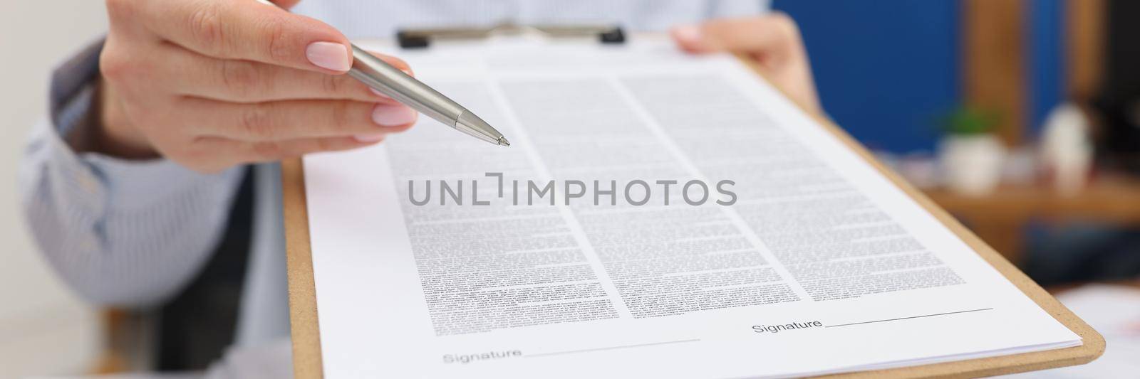 Close-up of businesswoman propose to sign paper, point with pen where to put personal signature. Prepared business document for client. Business concept