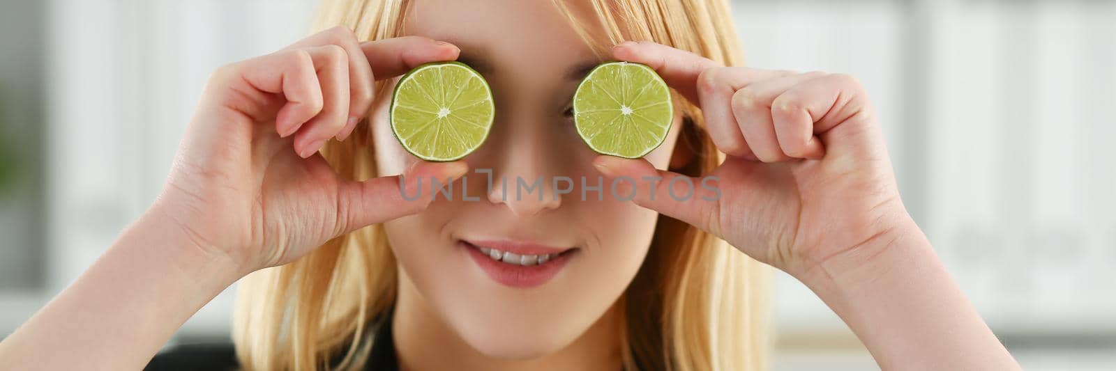 Portrait of girl hold cut fruit at eye level instead of glasses. Healthy diet, choose healthy lifestyle and add vitaminized nutrition. Kitchen, eat concept