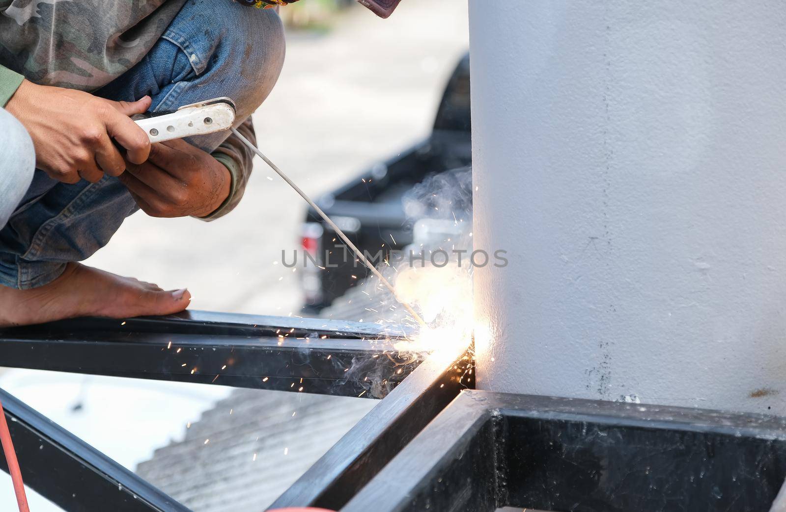 The welder is welding the steel structure to add to the house. by Manastrong