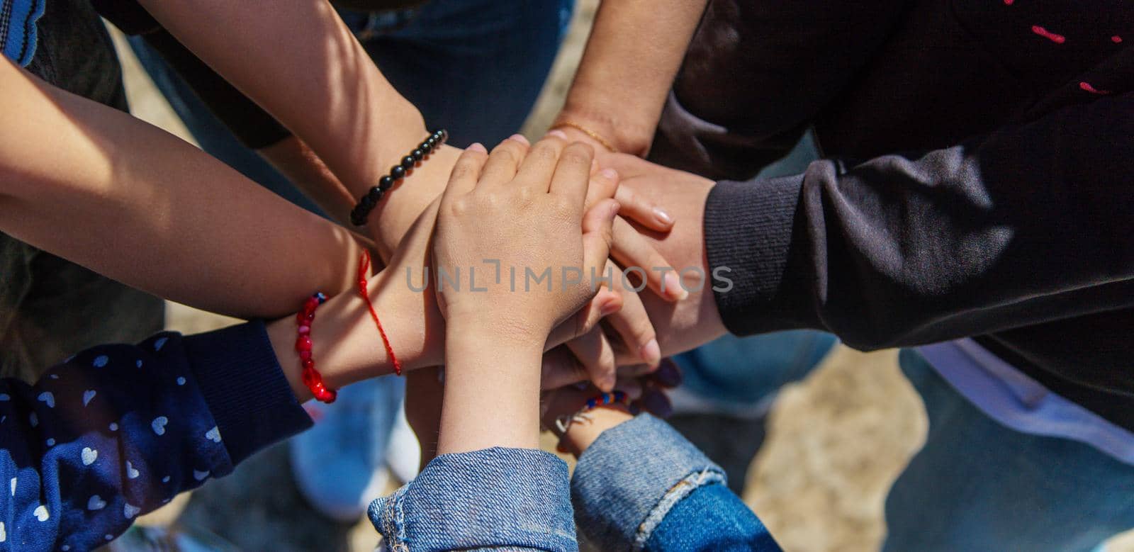 People put their hands together. Selective focus. by mila1784