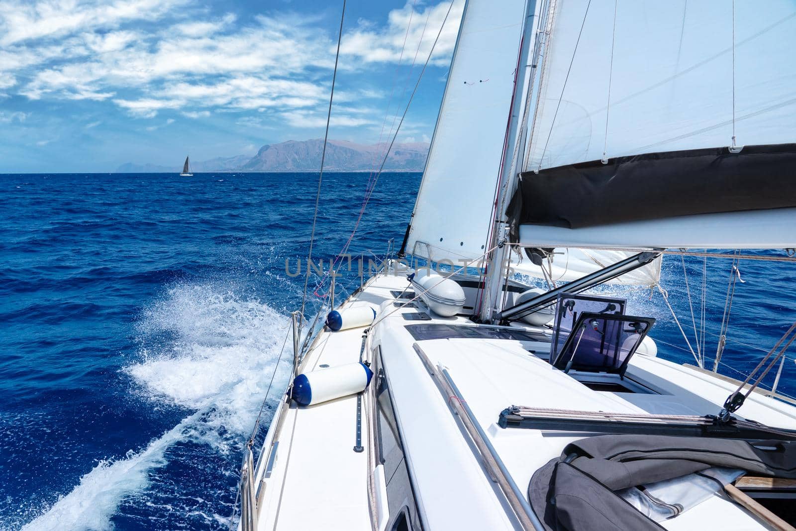 Summer yacht cruise on the Mediterranean Sea around the coast of italian island of Sicily on a hot summer day