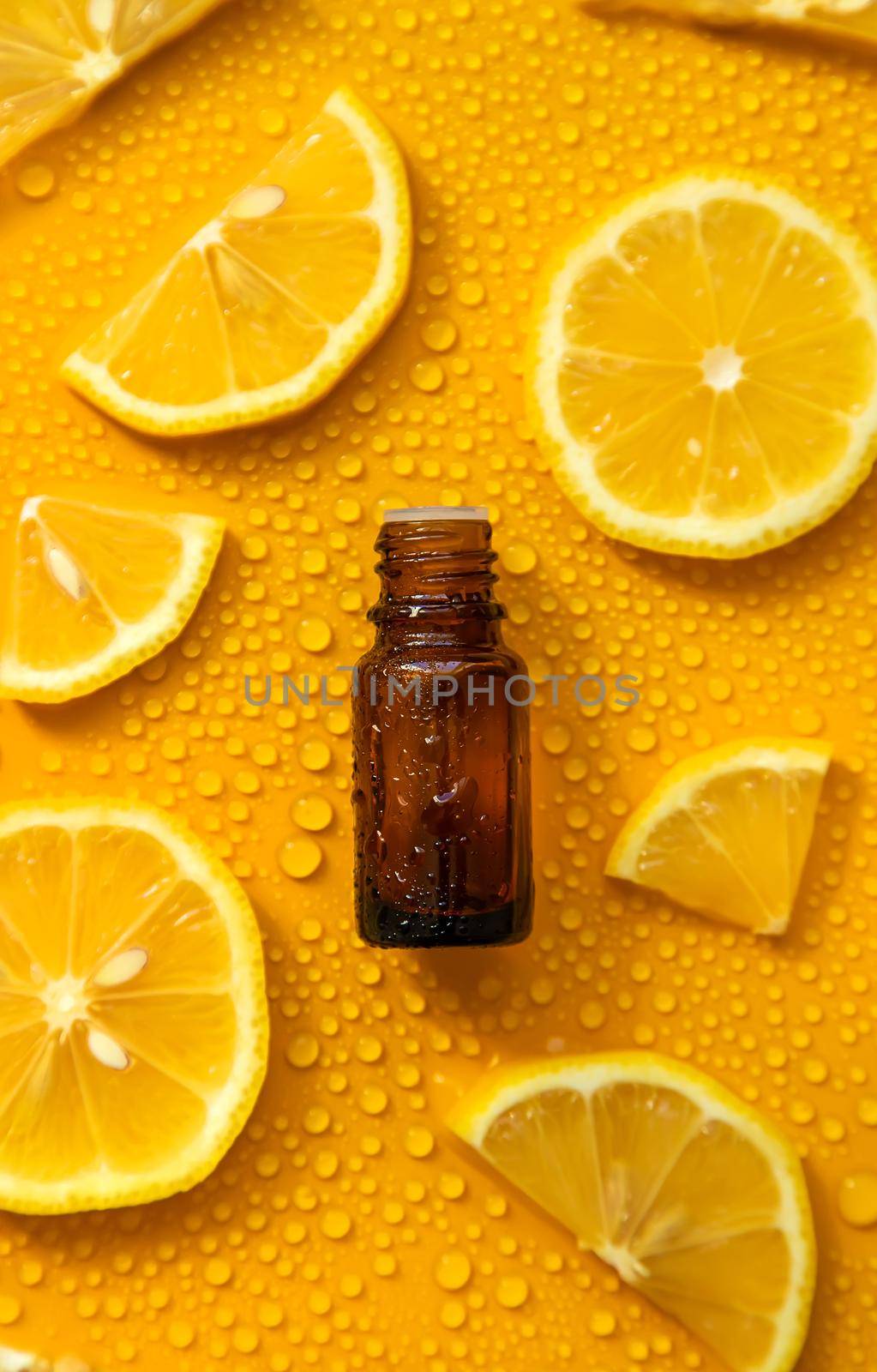 Bottle of cosmetics and drops of liquid, moisturizing lemon. Hyaluronic acid. Selective focus. Spa.