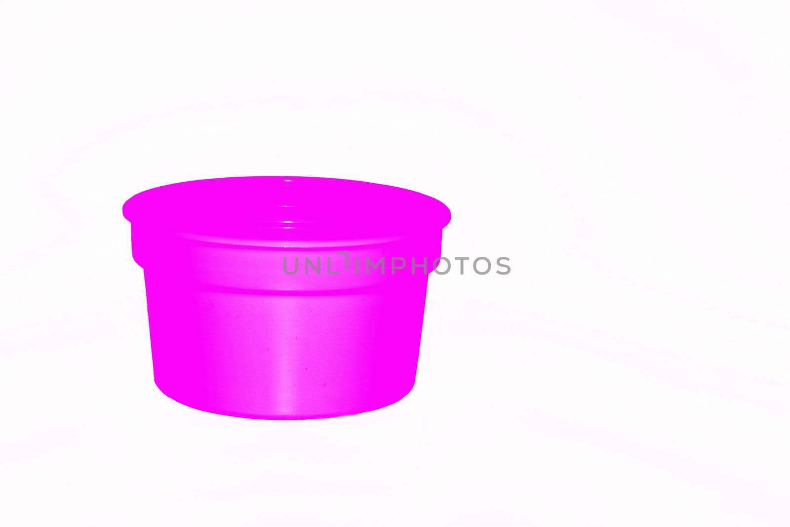 a wide mouthed cylindrical container made of glass or pottery and typically having a lid, used especially for storing product. Delicate pink purple plastic jar capacity of isolated on white