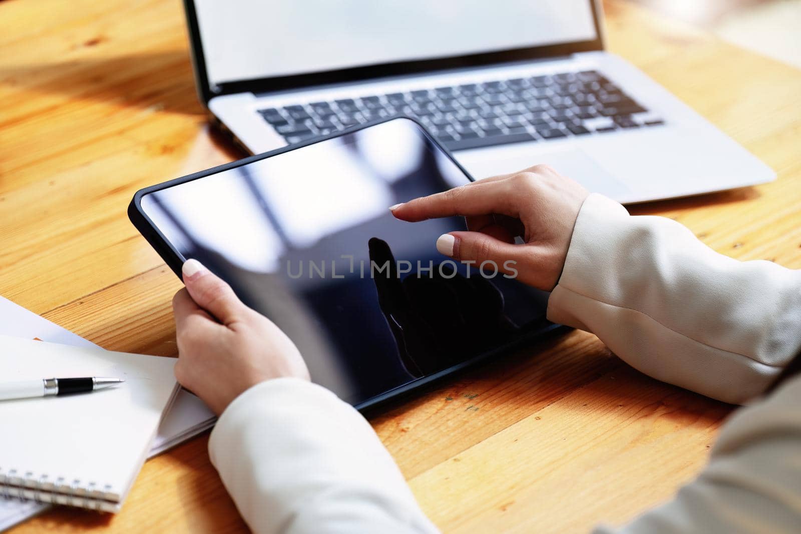 business woman using a tablet computer for data analysis, marketing, accounting.