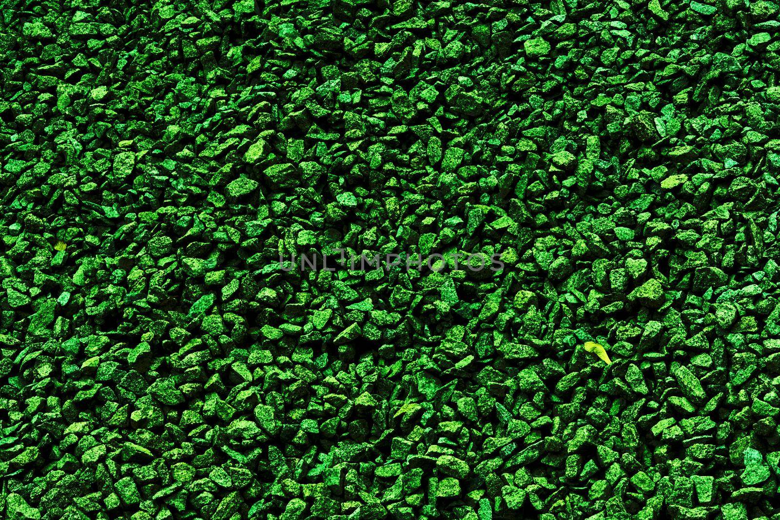 Green dark background of small stones for decor and text by jovani68