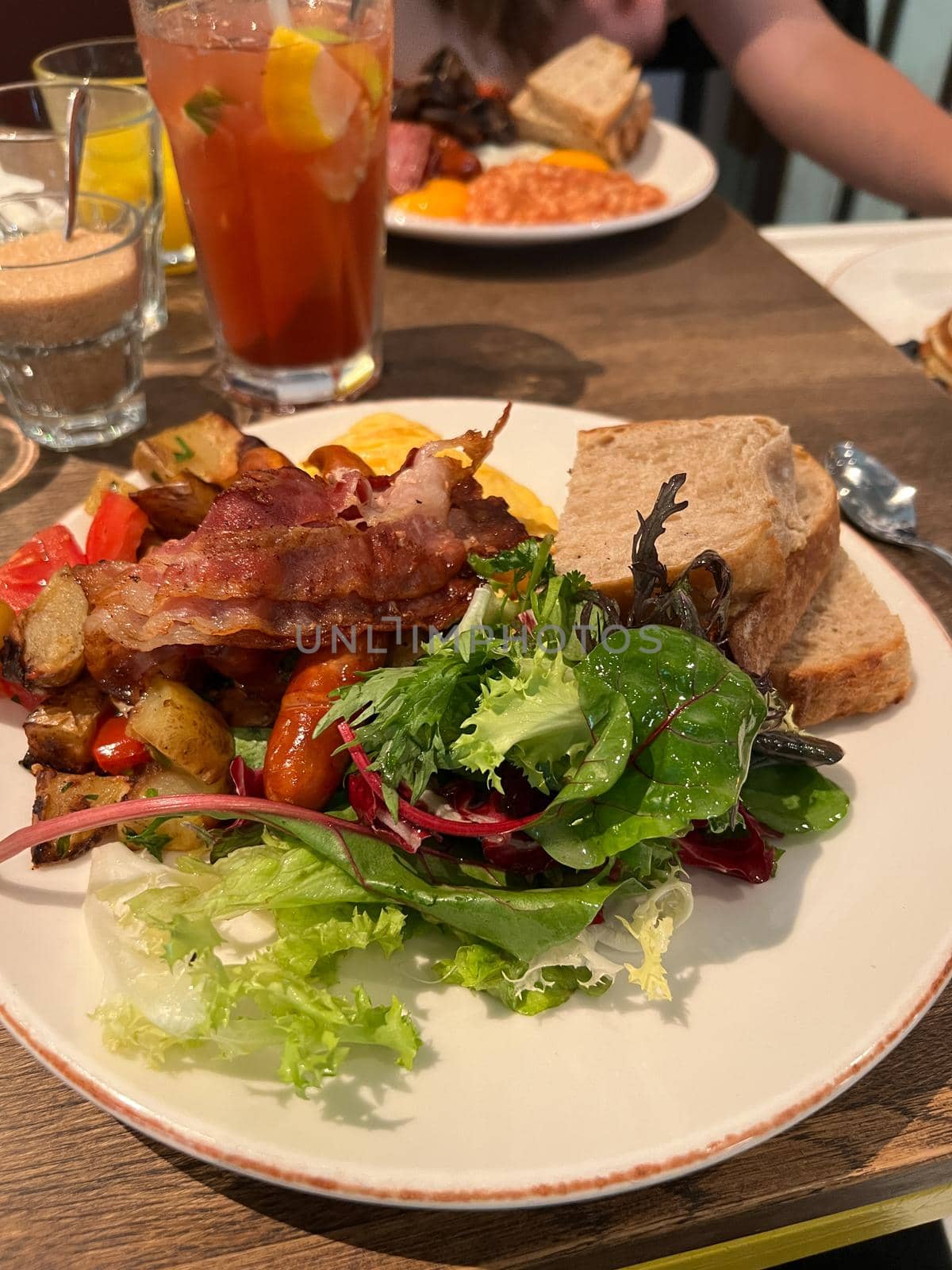 Meat with vegetables lies on a plate on a table in a restaurant. High quality photo