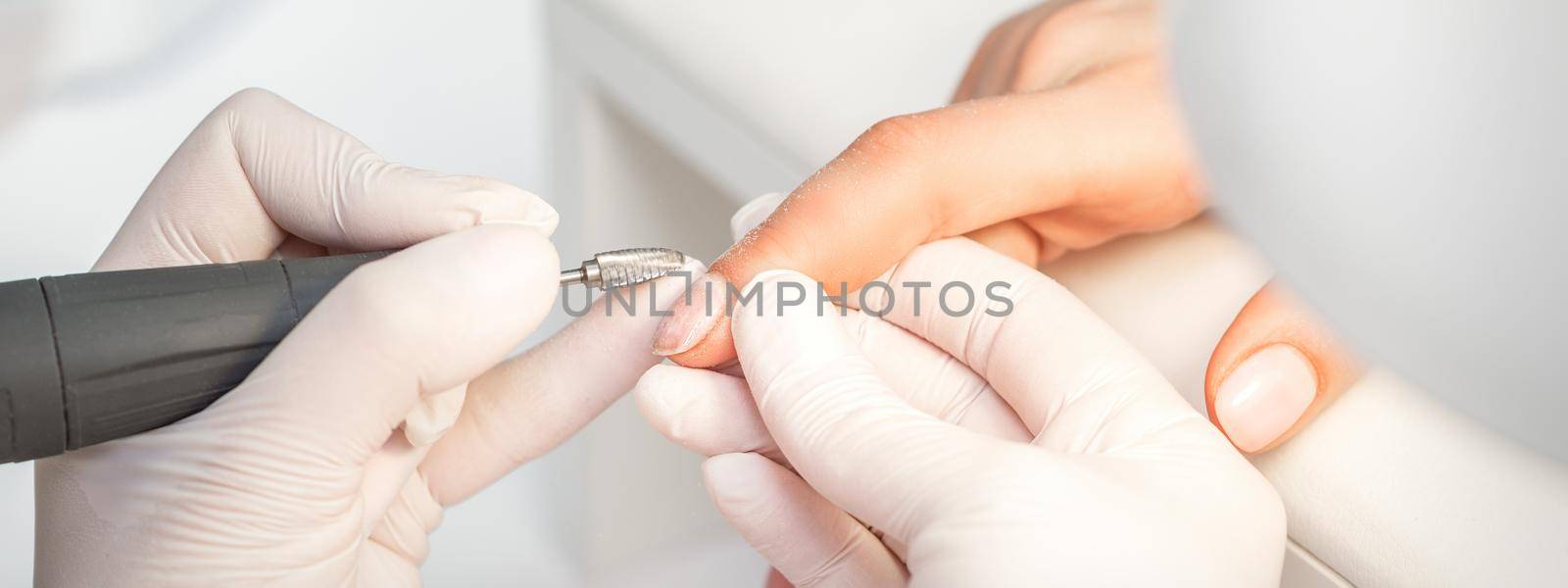 Manicure master removes nail polish by okskukuruza