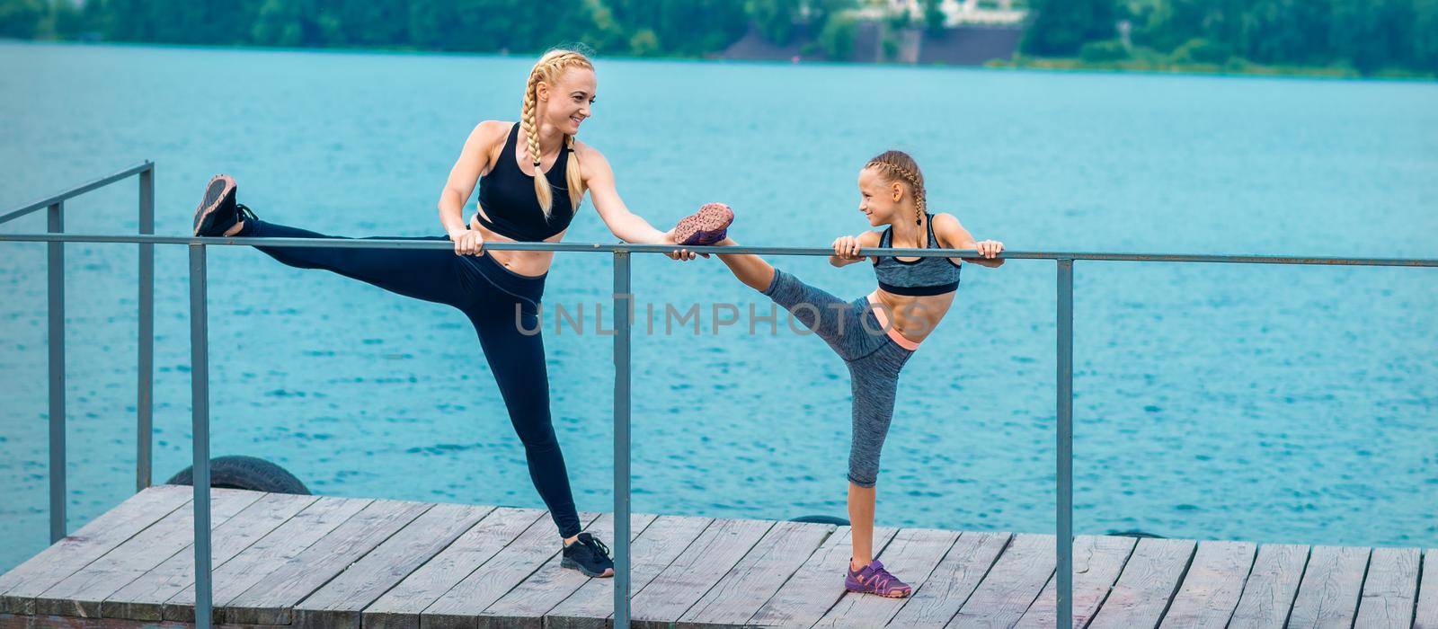 Woman and child are doing sport exercises by okskukuruza