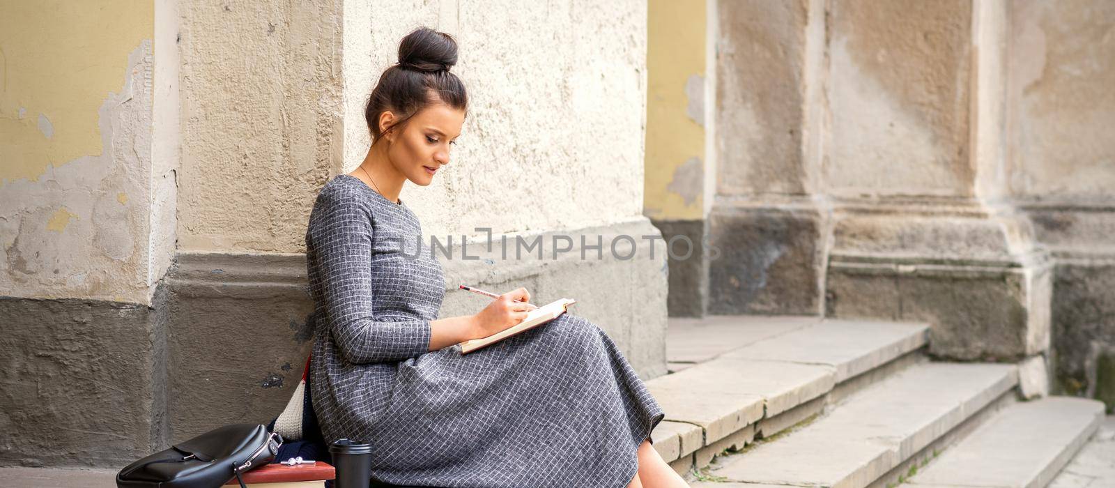 Student reading book on stairs by okskukuruza