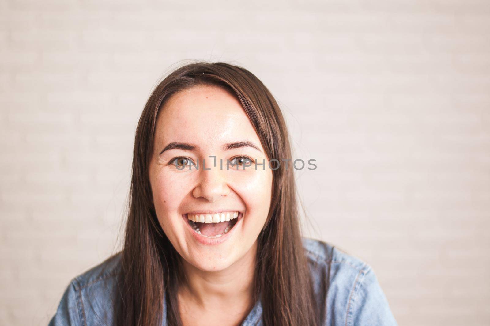 positive woman smiling on a light background by maramorosz