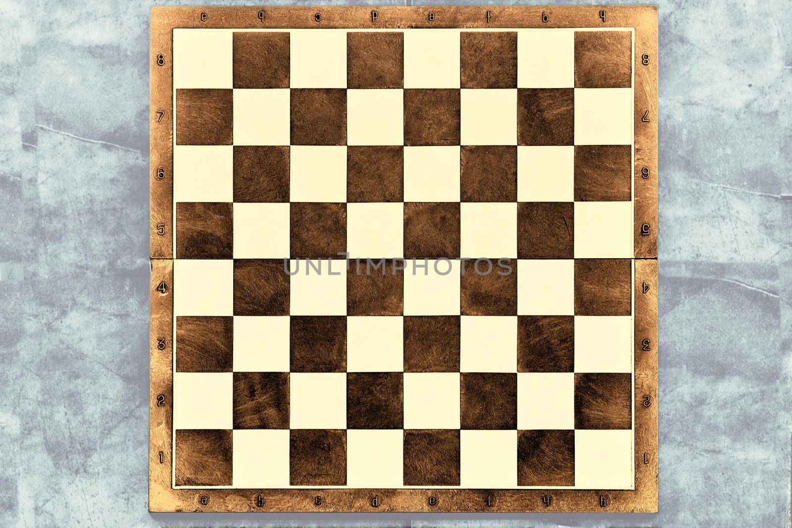 Brown dark chessboard on a gray marble surface by jovani68