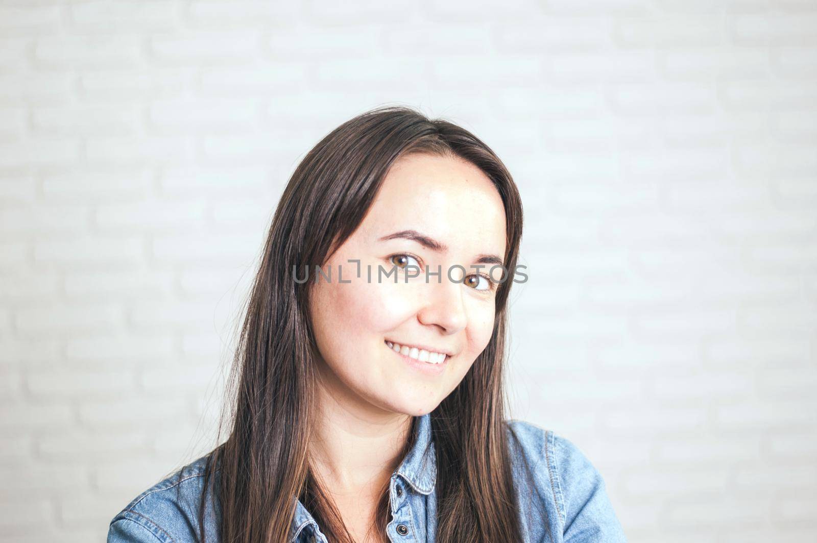 positive woman smiling on a light background by maramorosz