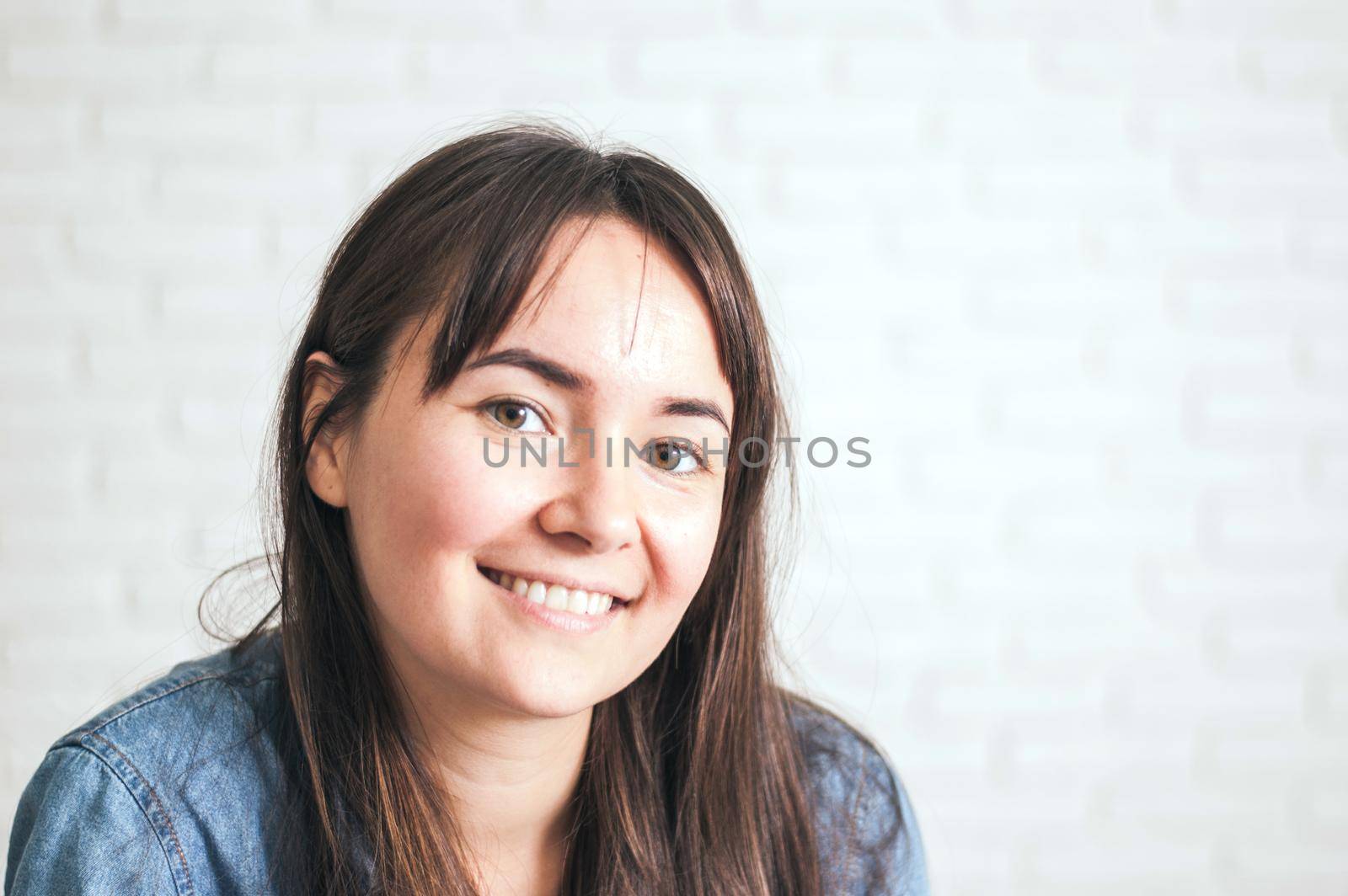 positive woman smiling on a light background. High quality photo
