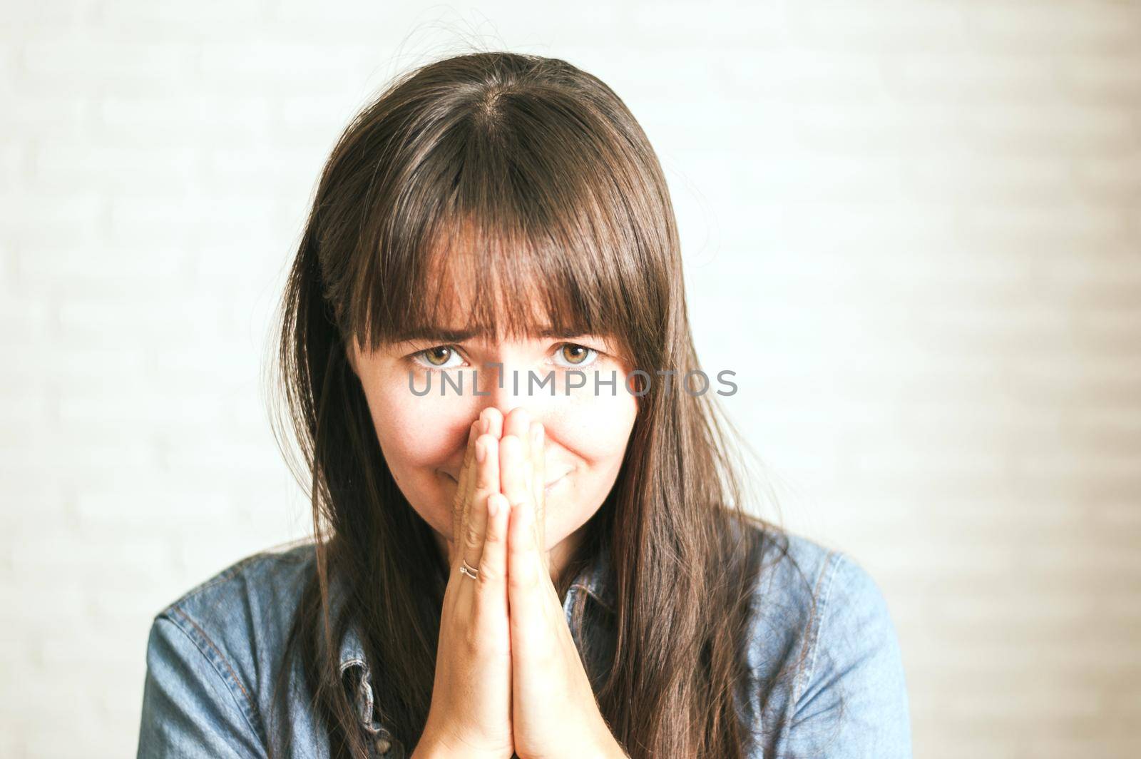 upset emotional woman on a light background by maramorosz