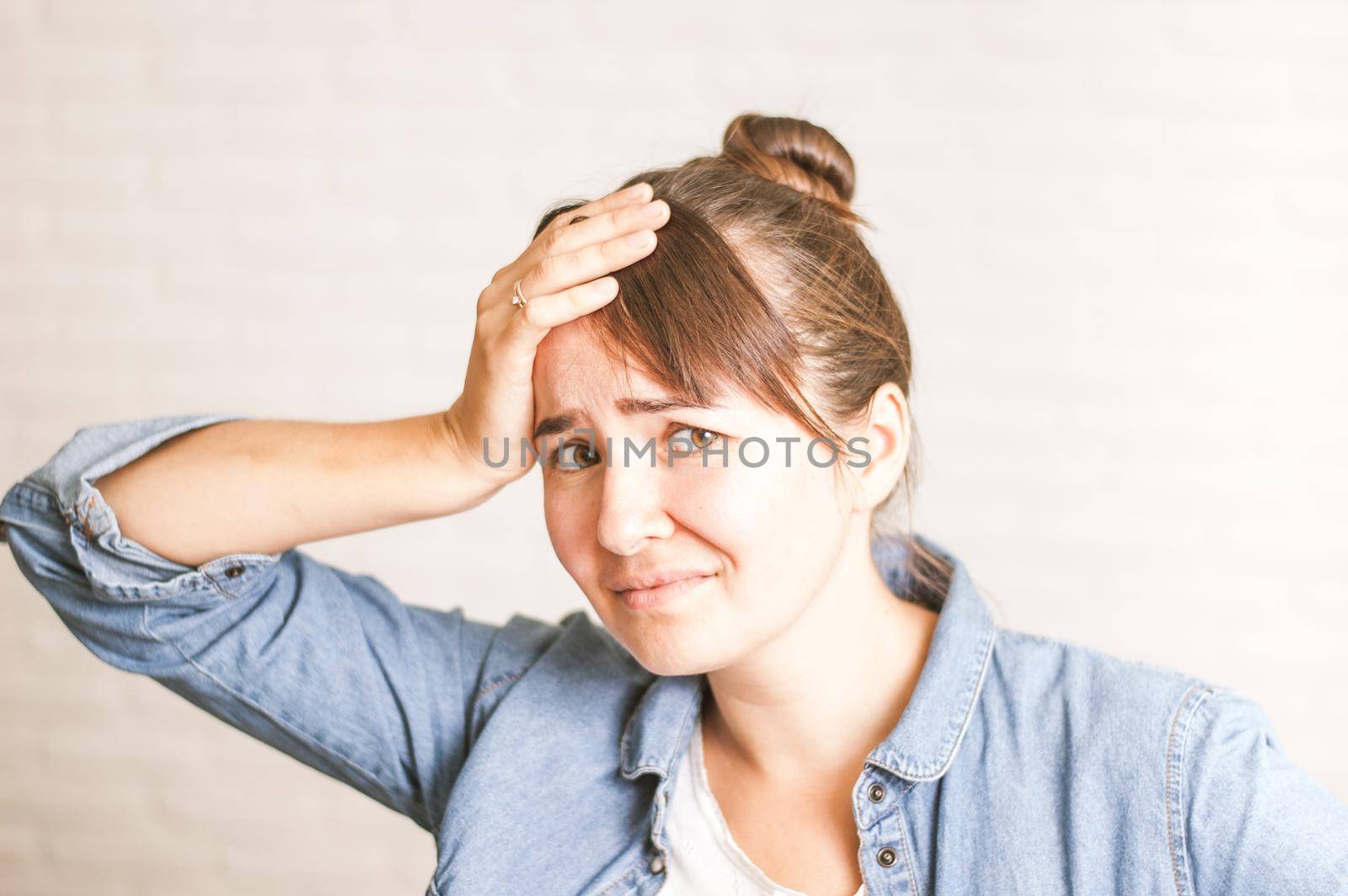 upset emotional woman on a light background. High quality photo