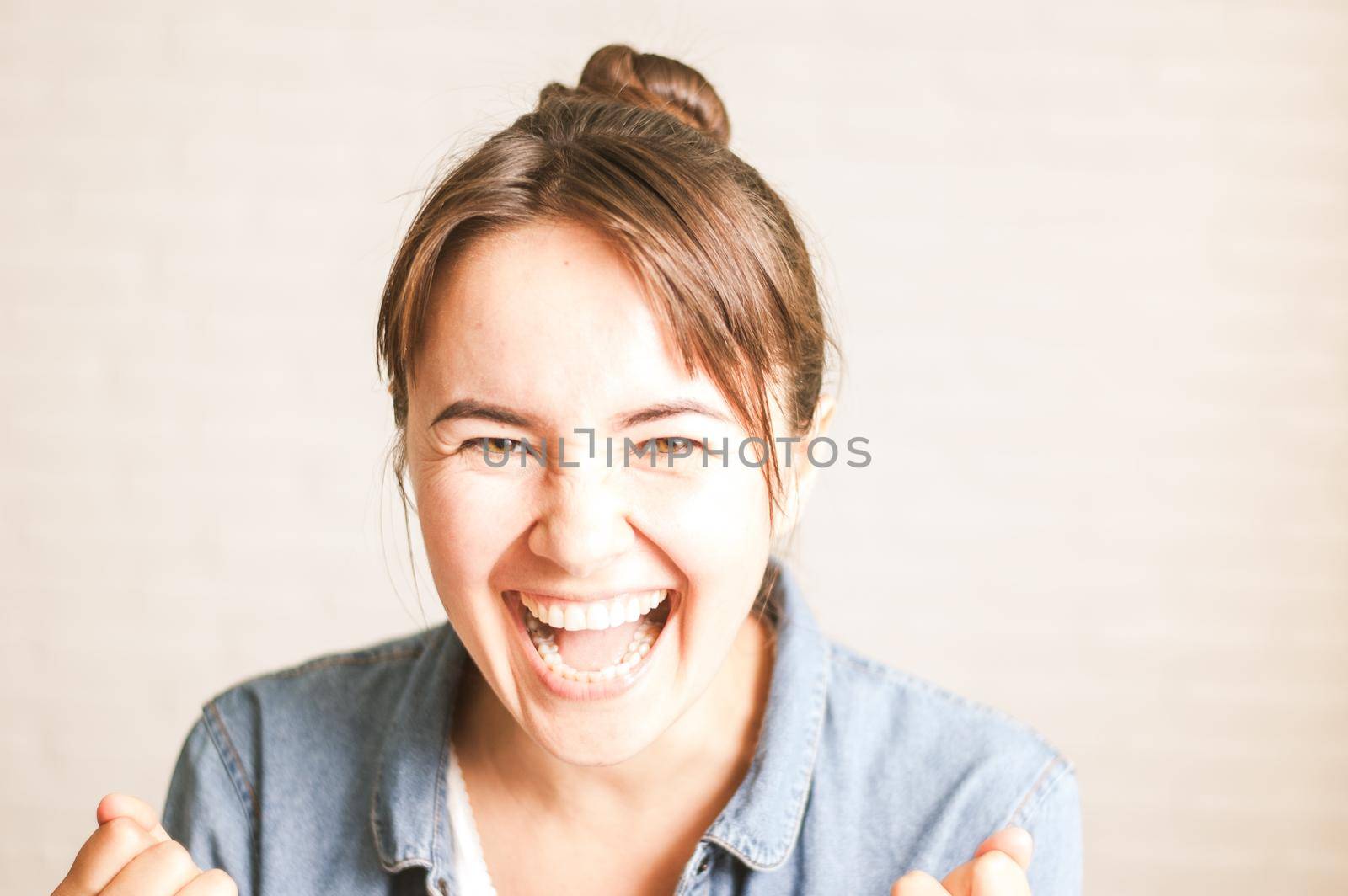 positive woman smiling on a light background by maramorosz