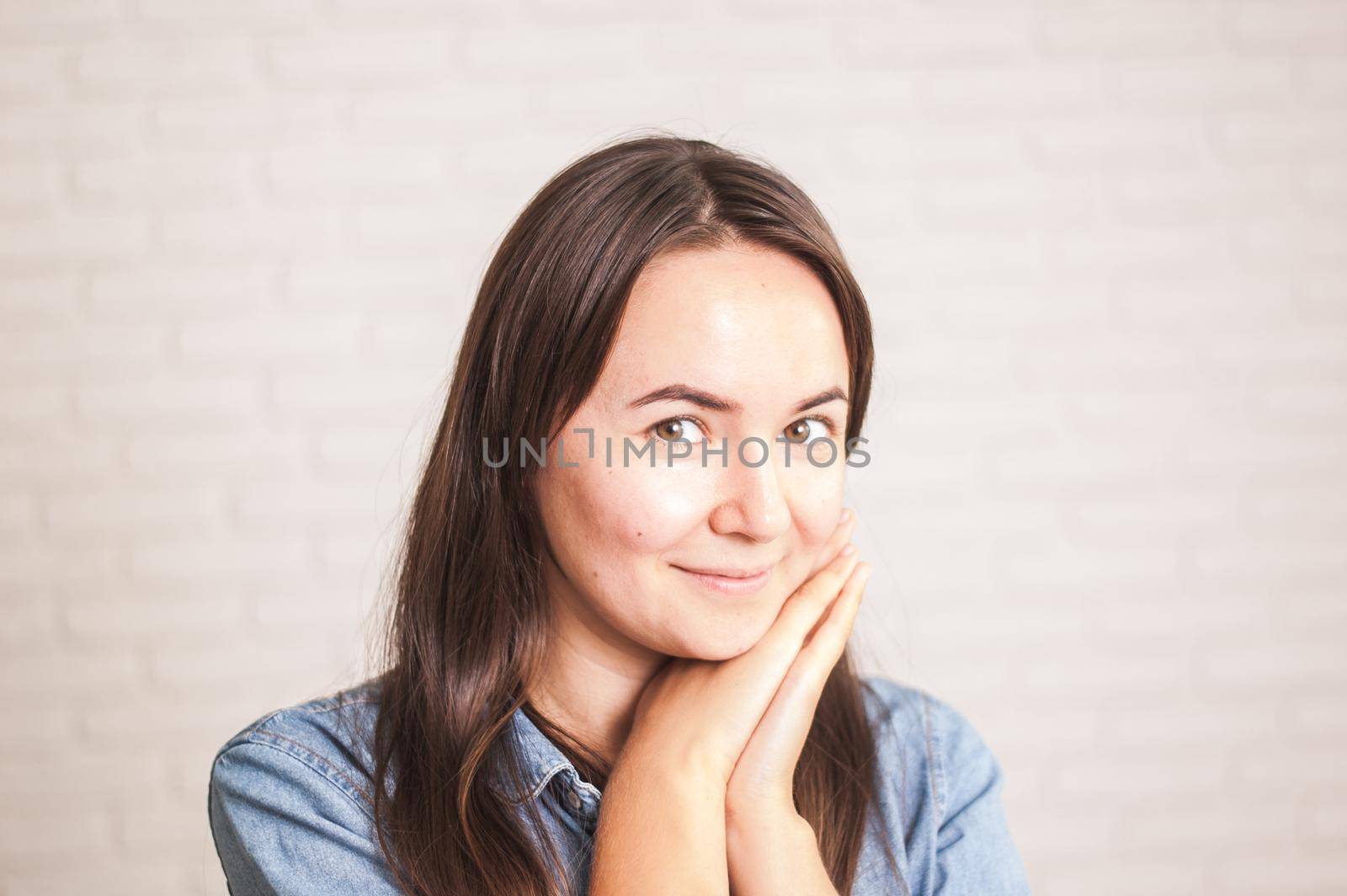 positive woman smiling on a light background by maramorosz