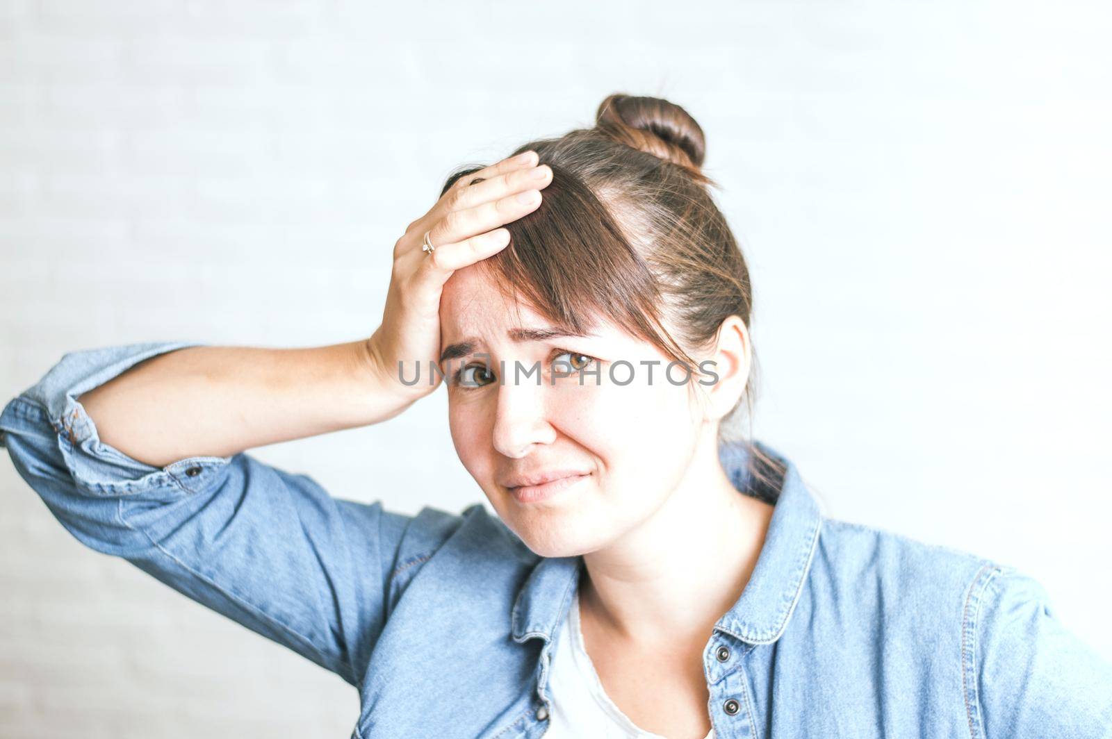 upset emotional woman on a light background. High quality photo