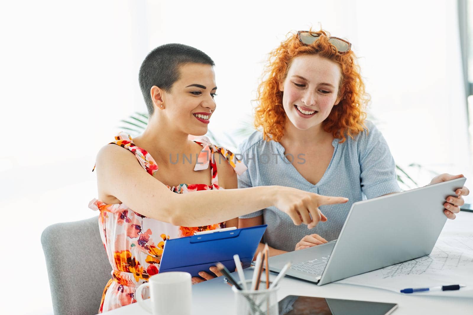 Happy young people friends with laptop in the office